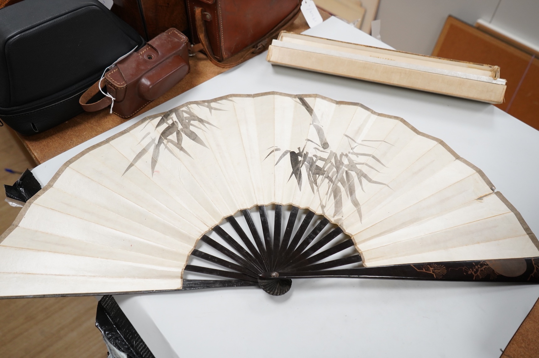 A gold mounted lace and hand painted fan and three others to include a lacquered example, one cased
